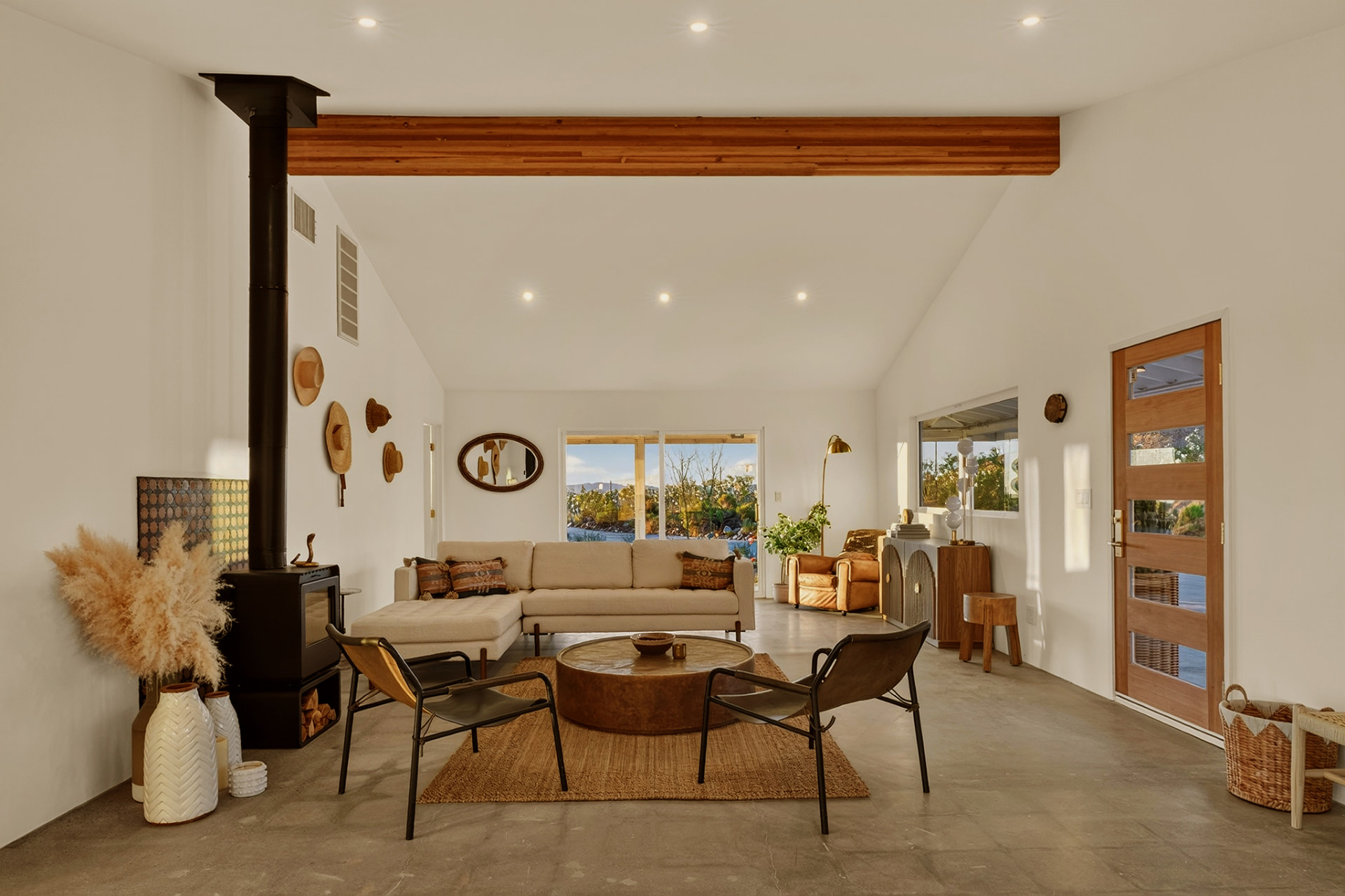Great room with wood stove, vaulted ceiling and desert views