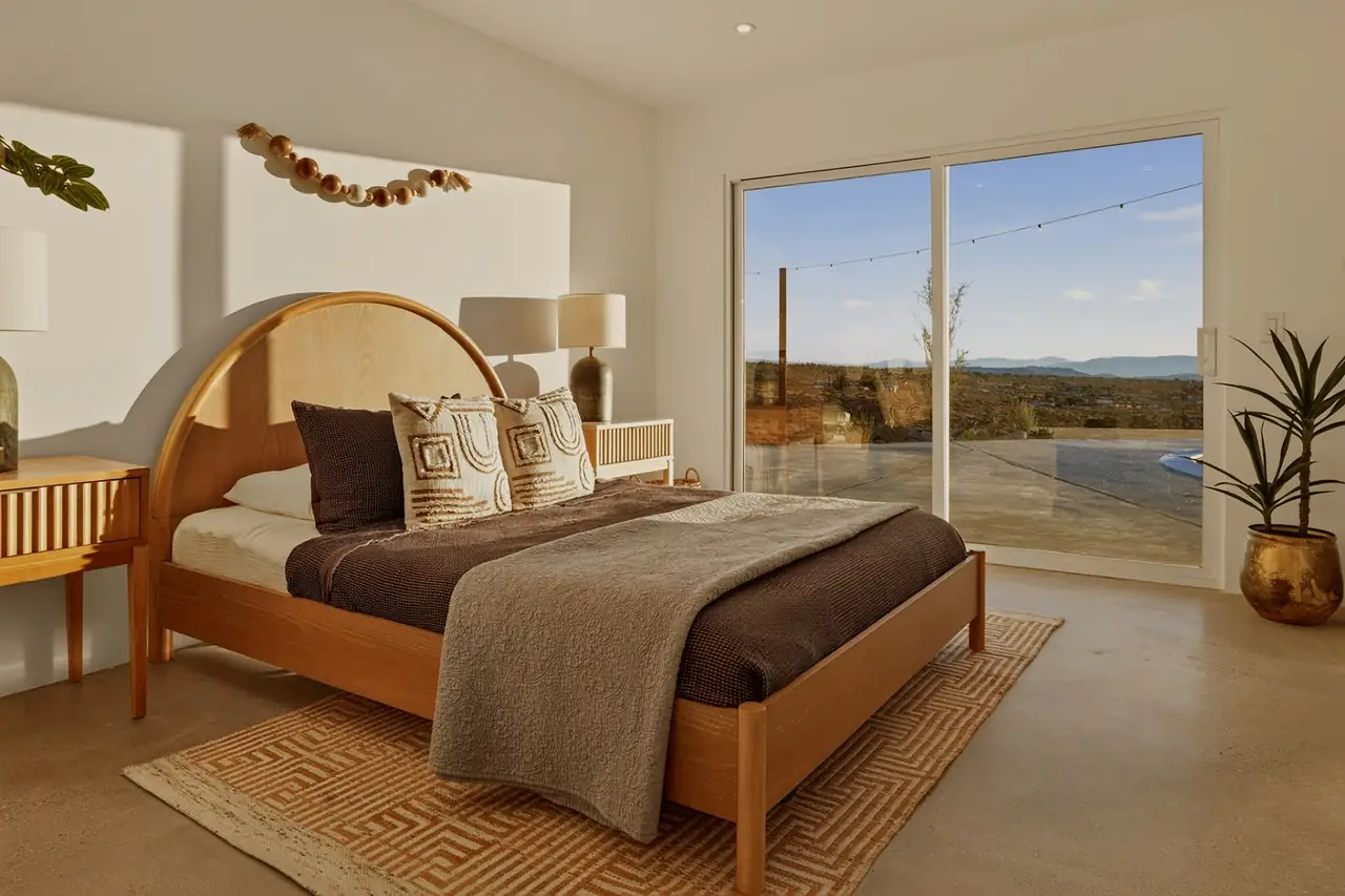 Bedroom with sculptural arch and natural light